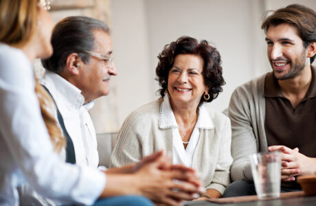 Senior adults talking with their adult children. T