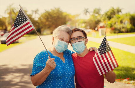mother and son waving the American flag outdoors