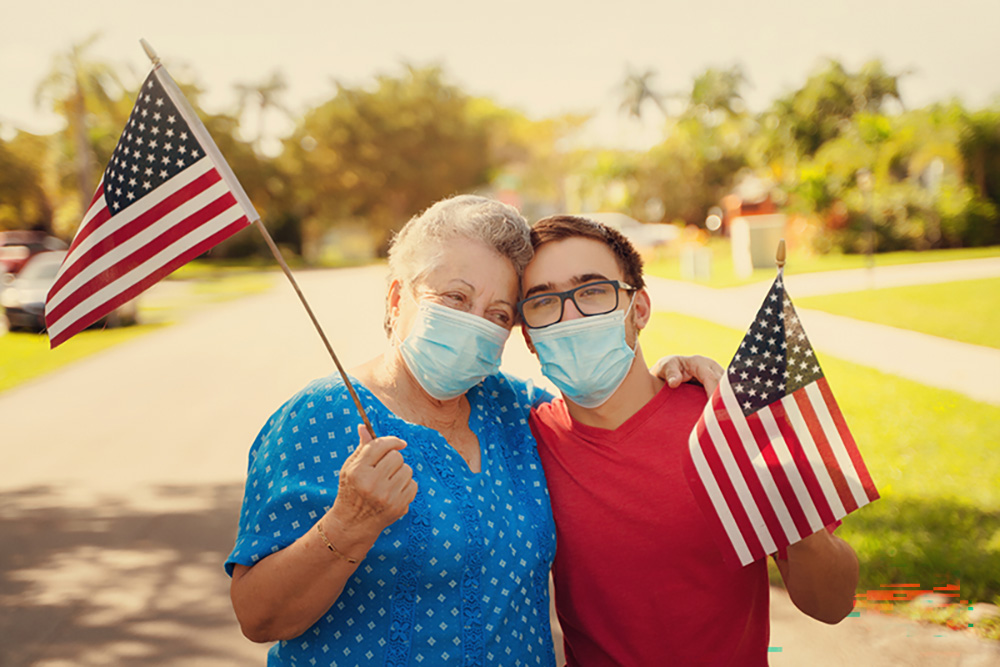 mother and son waving the American flag outdoors